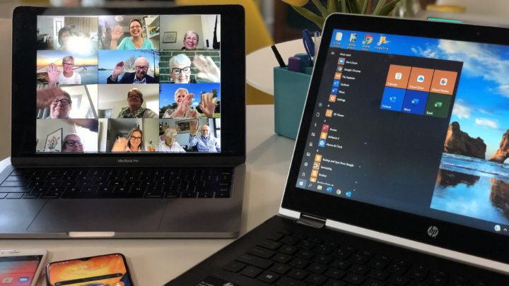 Zu sehen ist ein Laptop (rechts auf dem Bild) auf dem die Windows Einstellungen gehöffnet sind und rechts ist ein Tablet zu sehen. Auf dem Tablet ist eine Konferenz geschaltet, in der 16 winkende Senioren zugeschaltet sind.